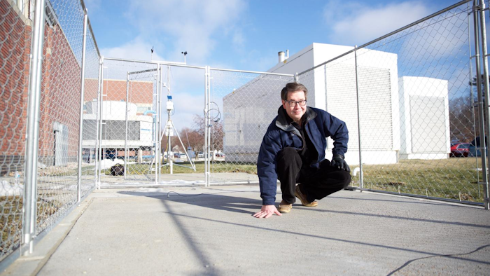 Chris Tuan, professor of civil engineering at the University of Nebraska-Lincoln, stands on a slab of conductive concrete that can carry enough electrical current to melt ice during winter storms.