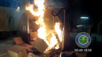 This file frame grab from video, provided by the Federal Aviation Administration (FAA) shows a test at the FAAs technical center in Atlantic City, N.J. last April, where a cargo container was packed with 5,000 rechargeable lithium-ion batteries. Officials say Jan. 27, 2016, a U.N. aviation panel is recommending a ban on shipping rechargeable batteries as cargo on passenger airliners because the batteries can create fires capable of destroying planes. (AP Photo/FAA, File)