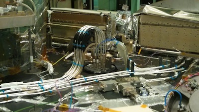 The 3D printed part, a black bracket holding the instrument's fiber-optic cables, is visible in the back of the ATLAS instrument.