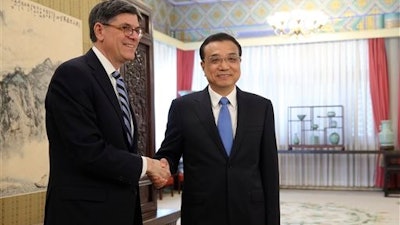 U.S. Secretary of the Treasury Jacob Lew, left, shakes hands with Chinese Premier Li Keqiang ahead of a meeting in Zhongnanhai Leadership Compound in Beijing, China, Monday, Feb. 29, 2016.