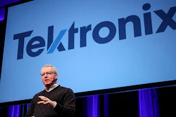 Tektronix President Pat Byrne unveils the new company logo at a recent employee meeting.