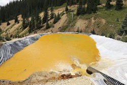 In this August 12, 2015, file photograph, water flows through a series of retention ponds after a spill at the Gold King mine near Silverton, Colorado.
