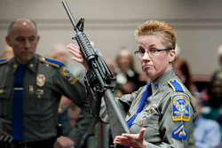 In this Jan. 28, 2013, file photo, firearms training unit Detective Barbara J. Mattson, of the Connecticut State Police, holds up a Bushmaster AR-15 rifle, the same make and model of gun used by Adam Lanza in the Sandy Hook School shooting, during a hearing of a legislative subcommittee, at the Legislative Office Building in Hartford, Conn. Lawyers for the company that made the rifle Lanza used at Sandy Hook Elementary School in 2012 are expected to ask a Connecticut judge Monday, Feb. 22, 2016, to dismiss a wrongful death lawsuit filed by families of some of the massacre victims. Freedom Group, the Madison, North Carolina parent company of AR-15 maker Bushmaster Firearms, says it’s protected by a 2005 federal law that shields gun manufacturers from most lawsuits over criminal use of their products.