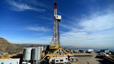 In this Dec. 9, 2015, file photo, crews work on stopping a gas leak at a relief well at the Aliso Canyon facility above the Porter Ranch area of Los Angeles. The gas-storage facility that spewed methane uncontrollably for almost four months, driving thousands of families from their homes, won't resume operations until it has undergone tougher tests than ever required before, a process that will take months and perhaps even longer.