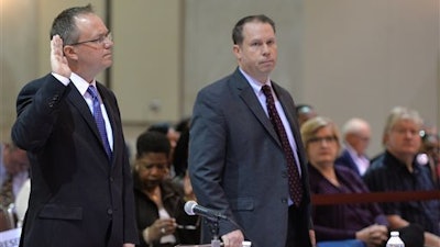 Jim Fisker-Andersen, left, director of ship services for TOTE Services, is sworn in at the beginning of his testimony at the hearings into the sinking of the El Faro on Friday, Feb. 19, 2016 in Jacksonville, Fla. All 33 aboard died after the vessel lost propulsion and was mauled by the winds of Hurricane Joaquin, a Category 4 storm, on Oct. 1, 2015.