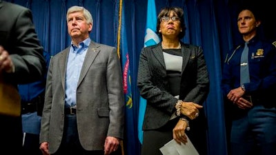 In a Jan. 27, 2016 file photo, Gov. Rick Snyder, left, stands beside Flint Mayor Karen Weaver as they prepare to field questions about the city's water crisis during a press conference in Flint, Mich. Newly hired outside engineers have been given a month to find Flint's underground lead water pipes, Snyder said Wednesday, Feb. 17, saying he wants service line replacements to begin promptly but not so quickly that it causes other problems.