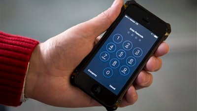 An iPhone is seen in Washington, Wednesday, Feb. 17, 2016. The San Bernardino County-owned iPhone at the center of an unfolding high-profile legal battle between Apple Inc. and the U.S. government lacked a device management feature bought by the county that, if installed, would have allowed investigators easy and immediate access.