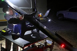 In this photo taken Monday, Feb. 15, 2016 a drone is prepared for flight in the Hluhluwe-iMfolozi Game Reserve in the KwaZulu Natal province. Once in flight conservationists can scan live video from a camera attached to the drone looking for poachers in the bush or next to the reserve to help curb the the slaughter of rhinos.