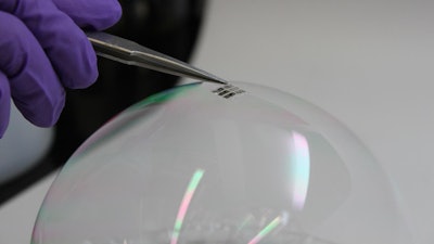 The MIT team has achieved the thinnest and lightest complete solar cells ever made, they say. To demonstrate just how thin and lightweight the cells are, the researchers draped a working cell on top of a soap bubble, without popping the bubble.