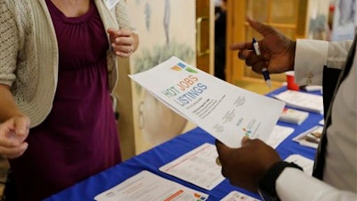 In this Tuesday, Oct. 6, 2015, file photo, a military veteran, at right, talks with a veterans outreach representative about employment opportunities, at a job fair for veterans, in Pembroke Pines, Fla. On Thursday, Feb. 25, 2016, the Labor Department reports on the number of people who applied for unemployment benefits the week before.