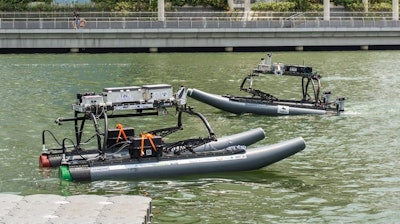 These are prototypes of two FAU unmanned surface vehicles (USVs) or robotic boats working cooperatively in close proximity on a busy waterway.