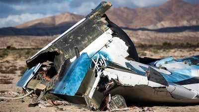 In this Nov. 1, 2014 file photo, wreckage lies near the site where a Virgin Galactic space tourism rocket, SpaceShipTwo, crashed in the desert near Mojave, Calif. One of the two pilots aboard was killed. Virgin Galactic will roll out a new copy of its space tourism rocket as it prepares to resume flight testing for the first time since the 2014 accident destroyed the original. The new spacecraft will be unveiled at Mojave Air and Space Port in Mojave Friday, Feb. 19, 2016.