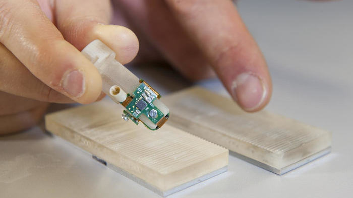 Detail of the bionic fingertip electronics that restored sensations of texture to amputee Dennis Aabo Sørensen, and the plastic gratings with rough and smooth textures.