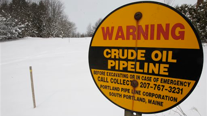 In this March 20, 2013 file photo, a sign marks the location of an oil pipeline in Irasburg, VT. The pipeline buried under three New England states that carried foreign crude oil from the Port of Portland to refineries in Montreal for 75 years has been mothballed.