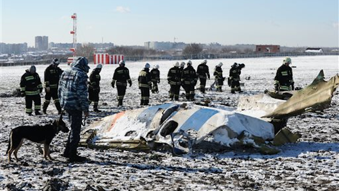 Russian Emergency Ministry employees investigate the wreckage of a crashed plane at the Rostov-on-Don airport, south of Moscow, Russia, Sunday, March 20, 2016.