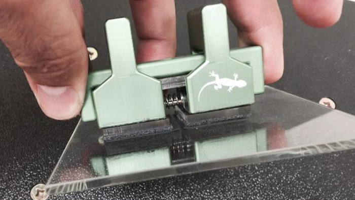 This gripping device is a material with synthetic hairs much like setae that are much thinner than a human hair. When a force is applied to make the tiny hairs bend, the positively charged part of a molecule within a slight electrical field attracts the negatively charged part of its neighbor resulting in 'stickiness.'