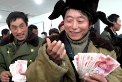 In this Dec. 29, 2006, file photo, Chinese migrant worker Zhang Guijun, foreground, reacts as he receives his delayed wages of 6,960 yuan in Shenyang, northern China's Liaoning province. Wage arrears are a major problem for Chinese laborers, especially migrants working on casual terms in the construction industry. Wages are supposed to be paid up before workers travel home for last month’s Lunar New Year holiday, but many contractors still fail to pay up.