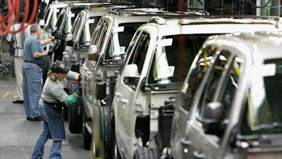 In this file photo, workers assemble vehicles at a GM auto assembly plant. Trying to make a stand in Michigan, Sen. Bernie Sanders said that Hillary Clinton was being disingenuous when she asserted that he opposed the auto bailout.