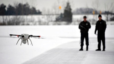 In this Jan. 15, 2015, file photo, Michigan State Police Sgt. Matt Rogers and Trooper Don Zinz bring the Aeryon SkyRanger in for a landing during a demonstration of the new Unmanned Aircraft System at the State Police training track in Dimondale, Mich. State transportation departments across the country are increasingly studying the use of unmanned aerial vehicles, better known as drones, for everything from inspecting bridges to helping clear car accidents.