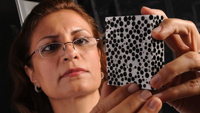 Afsaneh Rabiei examines a sample of metal foam. A new study by Rabiei finds that novel light-weight composite metal foams are significantly more effective at insulating against high heat than the conventional base metals and alloys, such as steel.
