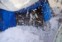 In this file photo, an Indian worker processes cotton at a factory on the outskirts of Jammu, India. U.S. seed giant Monsanto has threatened to pull its genetically modified crop technology from India if the government goes ahead with its plan to cut the company's royalty fees. Millions of small farmers have adopted genetically modified cotton seeds, making India one of the world's biggest producers of cotton.