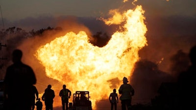 In this Sept. 9, 2010 photo, a massive fire roars through a neighborhood in San Bruno, Calif. U.S. officials are moving to strengthen natural gas pipeline safety rules following decades of fiery accidents including the 2010 California explosion that killed 8 people and injured more than 50.