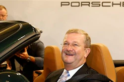 In this Nov. 26, 2008 file photo Wendelin Wiedeking, then CEO of German car manufacturer Porsche Automobil Holding SE, poses in a Porsche 911 during the financial press conference in Stuttgart, Germany. A court in Stuttgart on Friday, March 18, 2016 has acquitted Wiedeking and another former top executives of Porsche of alleged market manipulation in connection with a bid to take over Volkswagen AG.