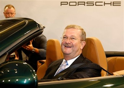 In this Nov. 26, 2008 file photo Wendelin Wiedeking, then CEO of German car manufacturer Porsche Automobil Holding SE, poses in a Porsche 911 during the financial press conference in Stuttgart, Germany. A court in Stuttgart on Friday, March 18, 2016 has acquitted Wiedeking and another former top executives of Porsche of alleged market manipulation in connection with a bid to take over Volkswagen AG.