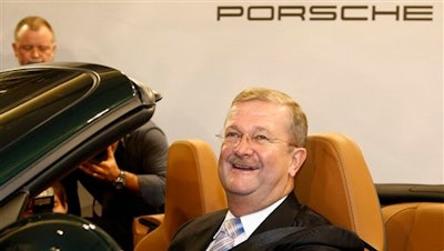 In this Nov. 26, 2008 file photo Wendelin Wiedeking, then CEO of German car manufacturer Porsche Automobil Holding SE, poses in a Porsche 911 during the financial press conference in Stuttgart, Germany. A court in Stuttgart on Friday, March 18, 2016 has acquitted Wiedeking and another former top executives of Porsche of alleged market manipulation in connection with a bid to take over Volkswagen AG.