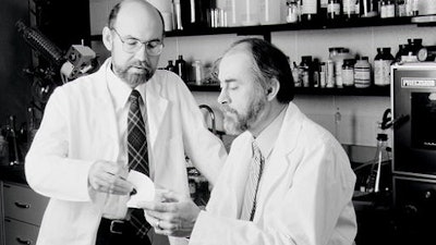 This undated photo shows Spencer Silver, left and Art Fry, right, holding a Post-It Note pad. Alan Amron, an inventor with 40 patents, claims that he invented what he called the Press-On Memo in 1973, a year before Fry and Silver, 3M scientists, developed what later became known as the Post-It Note. Amron is suing 3M for $400 million in damages.