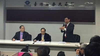 Foxconn, or also known as Hon Hai Precision Industry, spokesman Simon Hsing, right, announces the approval of the purchase of a controlling stake in Japan's Sharp Corp. during a press conference at the Taiwan Stock Exchange Corp. in Taipei, Taiwan, Wednesday, March 30, 2016.