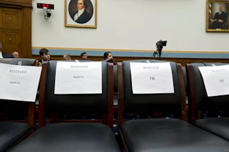 Empty reserved chairs are marked before the arrival of FBI Director James Comey, and others, on Capitol Hill in Washington, Tuesday, March 1, 2016, prior to the House Judiciary Committee hearing on 'The Encryption Tightrope: Balancing Americans' Security and Privacy.'