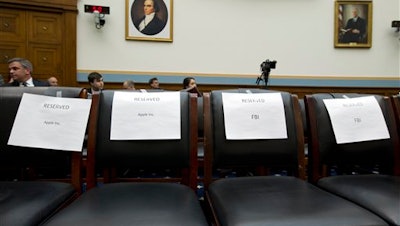 Empty reserved chairs are marked before the arrival of FBI Director James Comey, and others, on Capitol Hill in Washington, Tuesday, March 1, 2016, prior to the House Judiciary Committee hearing on 'The Encryption Tightrope: Balancing Americans' Security and Privacy.'