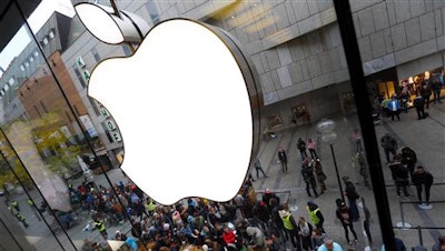 In this Friday, Sept. 25, 2015 file photo, people wait in front of an Apple store in Munich, Germany before the worldwide launch of the iPhone 6s. Tech and legal experts say if Apple were to create the iPhone-hacking software demanded by the FBI, it would have a tough time staying secret, given the 'potentially unlimited' number of people that would likely get a look at its inner workings.