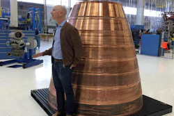 Amazon.com founder Jeff Bezos stands next to a copper exhaust nozzle to be used on a space ship engine during a media tour of Blue Origin, the space venture he founded, Tuesday, March 8, 2016, in Kent, Wash. The private space company opened its doors to the media for the first time on Tuesday to give a glimpse of how organizations like Blue Origin are creating the next generation of rockets for private and public use.