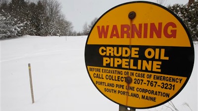 In this March 20, 2013 file photo, a sign marks the location of an oil pipeline in Irasburg, VT. The pipeline buried under three New England states that carried foreign crude oil from the Port of Portland to refineries in Montreal for 75 years has been mothballed.