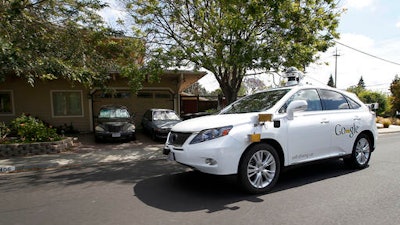 In this Wednesday, May 13, 2015, file photo, Google's self-driving Lexus car drives along street during a demonstration at Google campus on in Mountain View, Calif. As Google cars encounter more and more of the obstacles and conditions that befuddle human drivers, the autonomous vehicles are likely to cause more accidents, such as a recent low-speed collision with a bus.