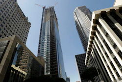 Passerby's look up at the Wilshire Grand Tower on South Figueroa Street where a worker fell to his death on Thursday, March 17, 2016. A fire department spokesperson said the the construction worker plunged 50 stories to his death from the building under construction and hit the back of a passing car in downtown Los Angeles.
