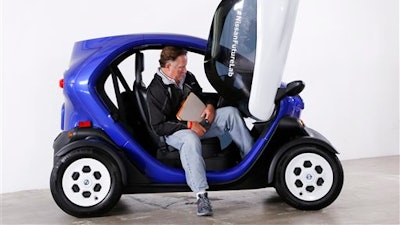 In this Monday, March 21, 2016, photo, a man sits in the driver's seat of a Nissan Micro Mobility Concept vehicle at the New York International Auto Show. The electric vehicle is designed to transport two people over short distances. The batteries can be recharged in four hours and the range is up to 62 miles (100 kilometers).