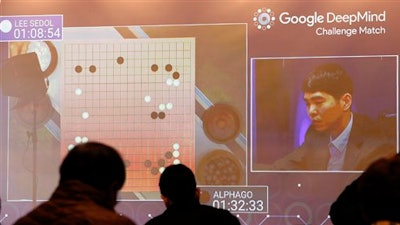South Korean professional Go player Lee Sedol, right, appears on the screen during the second match of the Google DeepMind Challenge Match against Google's artificial intelligence program, AlphaGo at the media room in Seoul, South Korea, Thursday, March 10, 2016. Google's computer program AlphaGo defeated its human opponent, South Korean Go champion Lee Sedol, on Wednesday in the first face-off of a historic five-game match.