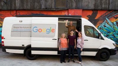 In this Wednesday, March 9, 2016 photo, Google User Experience Researcher John Webb, background, Dawn Herman, left, Henry Liang, center, and Victoria Sosik pose for a photo with Google's User Experience van in New York.