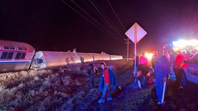 Passengers gather after a train derailed near Dodge City, Kan., Monday, March 14, 2016. An Amtrak statement says the train was traveling from Los Angeles to Chicago early Monday when it derailed just after midnight.