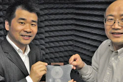 Liang Dong and Jiming Song, left to right, hold their meta-skin inside the experiment they used to measure the effectiveness of their radar-trapping device.