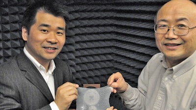 Liang Dong and Jiming Song, left to right, hold their meta-skin inside the experiment they used to measure the effectiveness of their radar-trapping device.