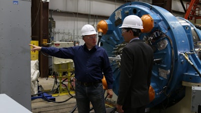 NREL researchers are completing testing of a next-generation drivetrain, shown here undergoing rigorous tests at the National Wind Technology Center’s 2.5-megawatt dynamometer. NREL’s testing validates the technology prior to commercialization. Shown here are NREL senior engineer and project lead Jonathan Keller (left) and DOE technology manager Nick Johnson.