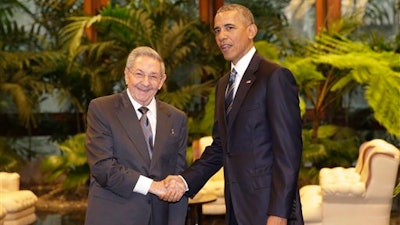 Cuban President Raul Castro, left, shakes hands with U.S. President Barack Obama during a meeting in Revolution Palace, Monday, March 21, 2016. Brushing past profound differences, President Obama and President Castro sat down for a historic meeting, offering critical clues about whether Obama's sharp U-turn in policy will be fully reciprocated.