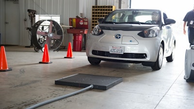 Researchers test a wireless charger on the fully-electric Toyota Scion iQ at Oak Ridge National Laboratory.