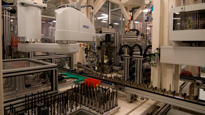 Washers of various sizes build up on a piston rod for assembly, with differing levels of air and oil fill to suit the specifications of the individual products at ThyssenKrupp; modular, programmable work cells provide great flexibility in production.