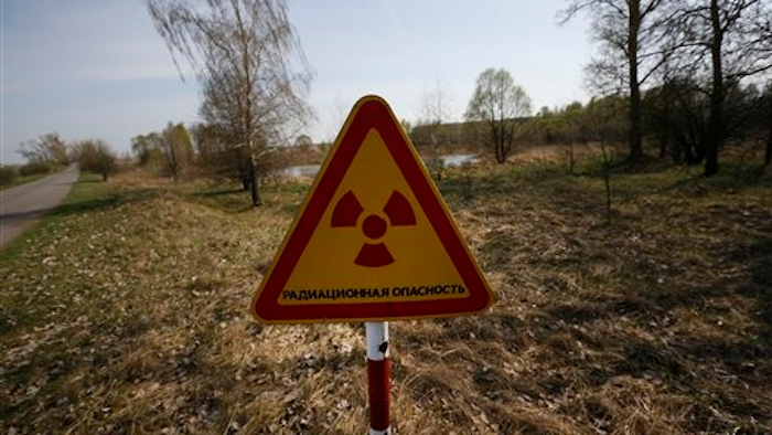 This sign is placed a mere two kilometers from Nikolai Chubenok farm, where milk has tested at 10 times safe levels of radiation.