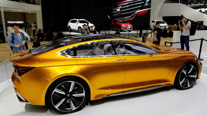 Journalists take pictures of the Roewe Vision R Concept on display at the Beijing International Automotive Exhibition. Automakers showcased a new generation of luxurious SUVs at China's biggest auto show of the year to lure buyers in its cooling, crowded market. (AP Photo/Andy Wong)